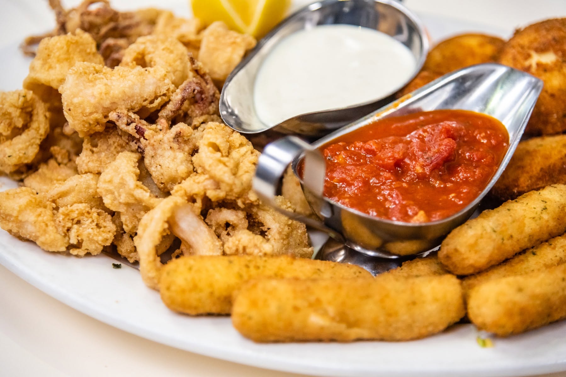 Fried calamari with lemon and golden mozzarella sticks