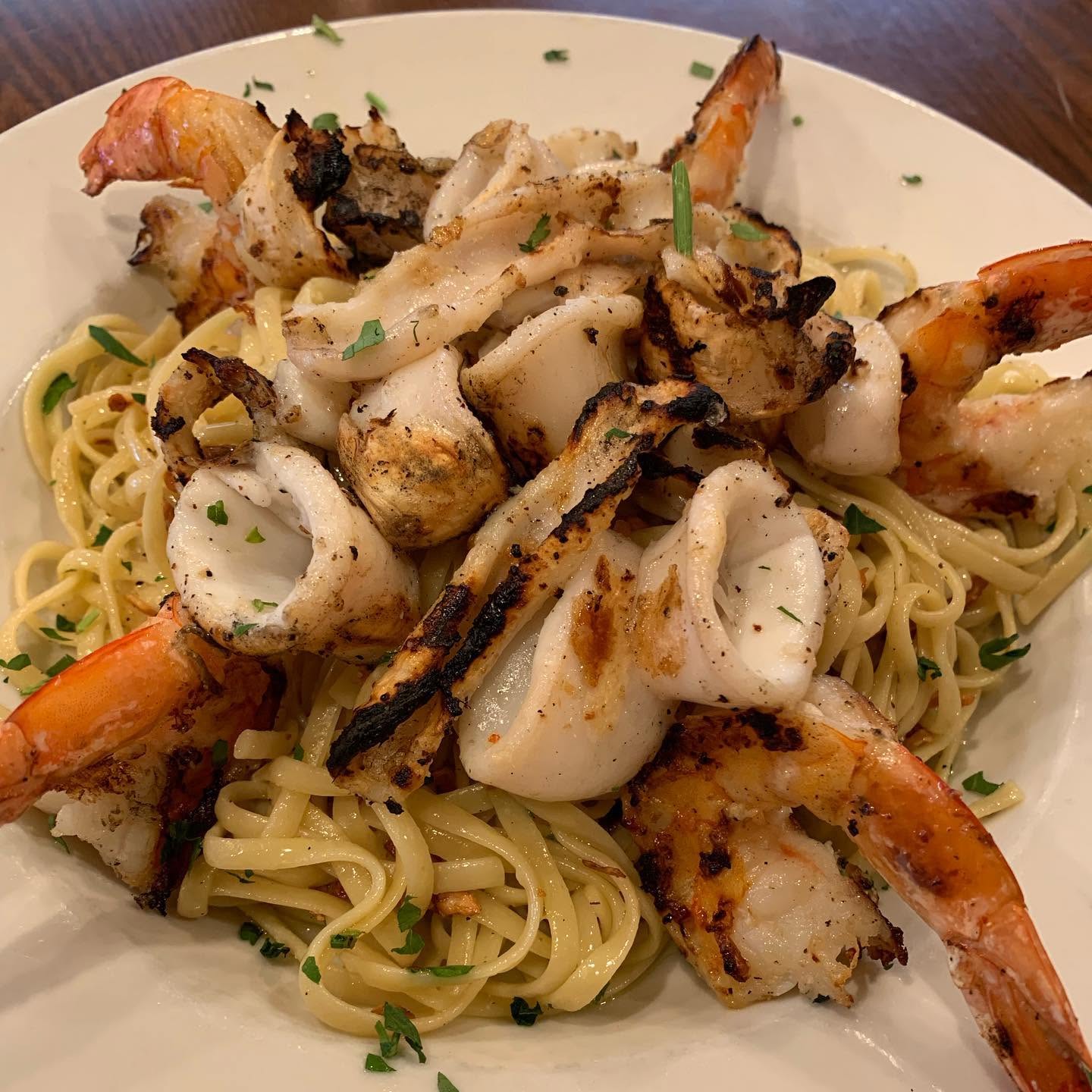 Grilled seafood platter with shrimp, calamari, and scallops
