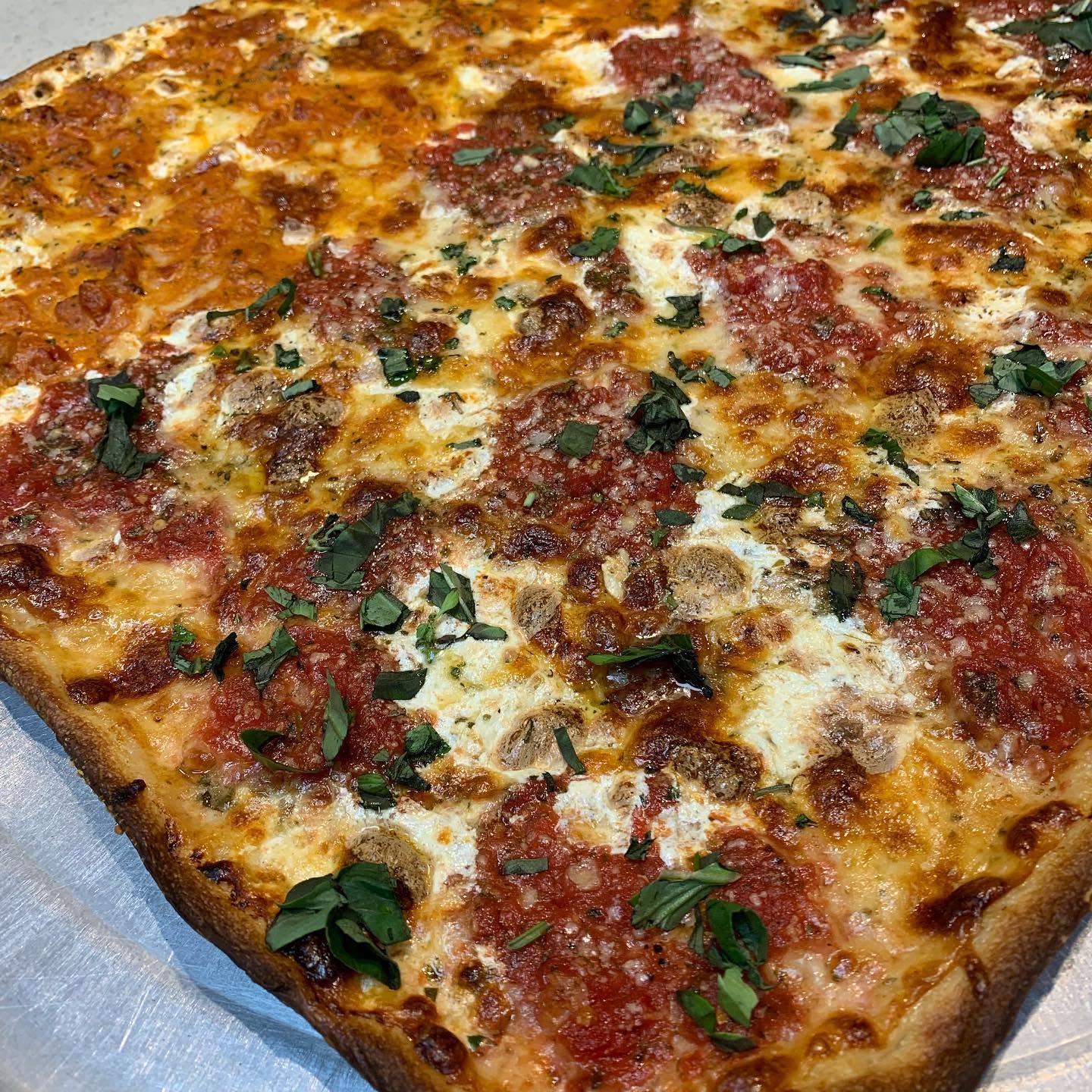 Sicilian square pizza with tomato and mozzarella