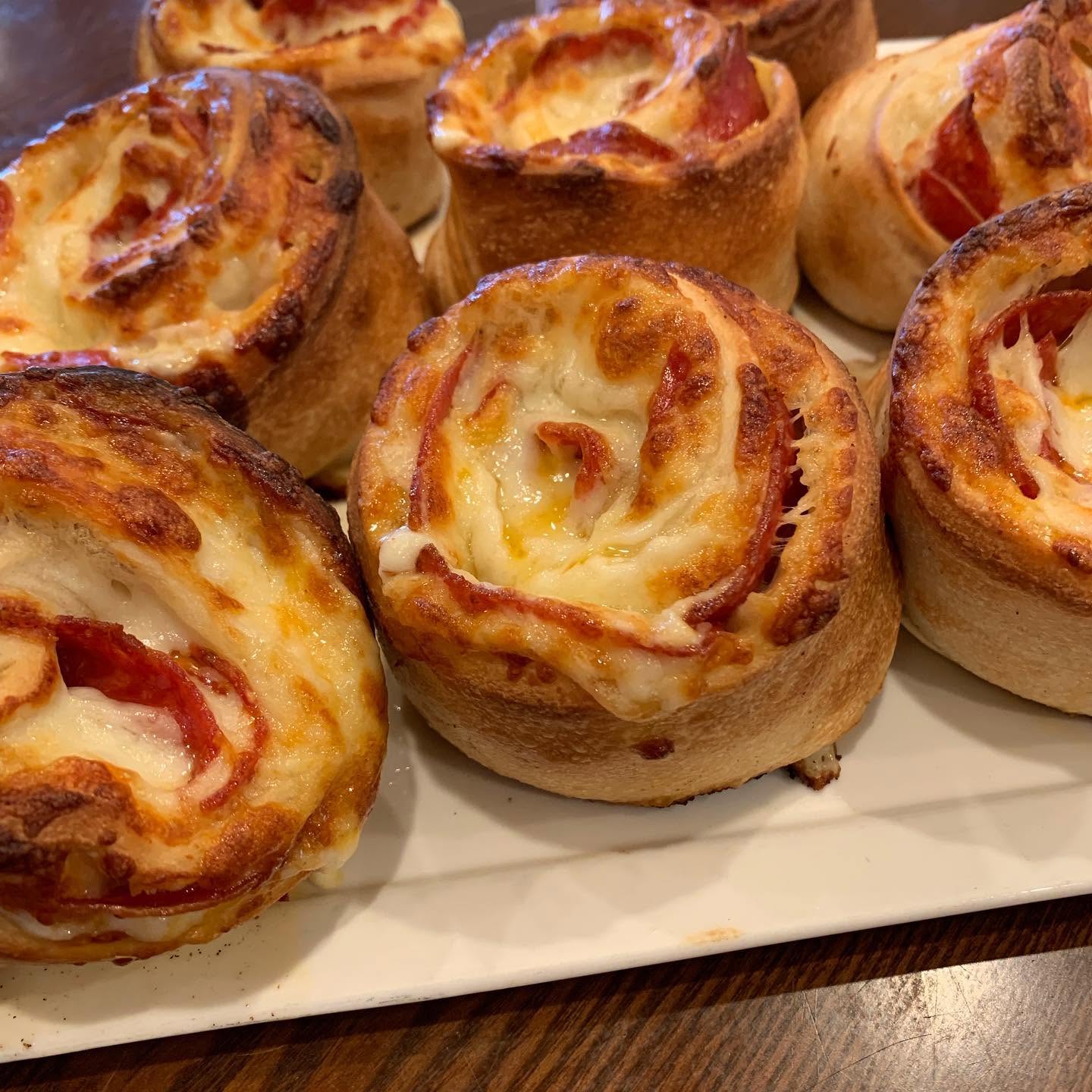 Pepperoni pizza rolls on a white plate