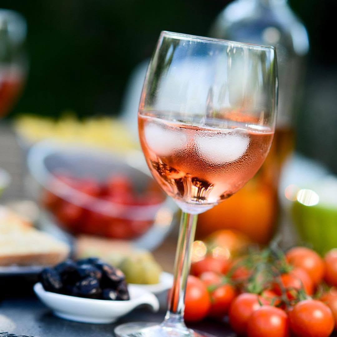 Glass of ros&eacute; wine with cherry tomatoes