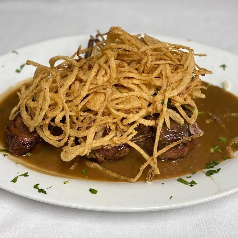 Grilled steak medallions topped with crispy onions