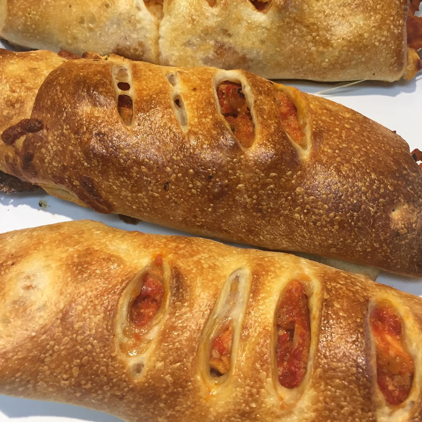 Baked pepperoni stromboli loaves with a golden crust