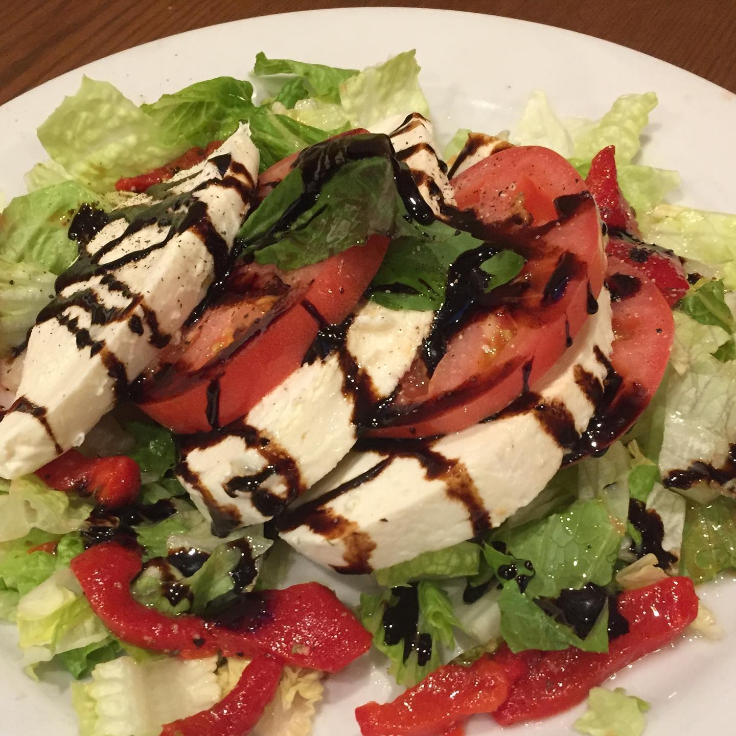 Caprese salad with balsamic glaze and roasted red peppers