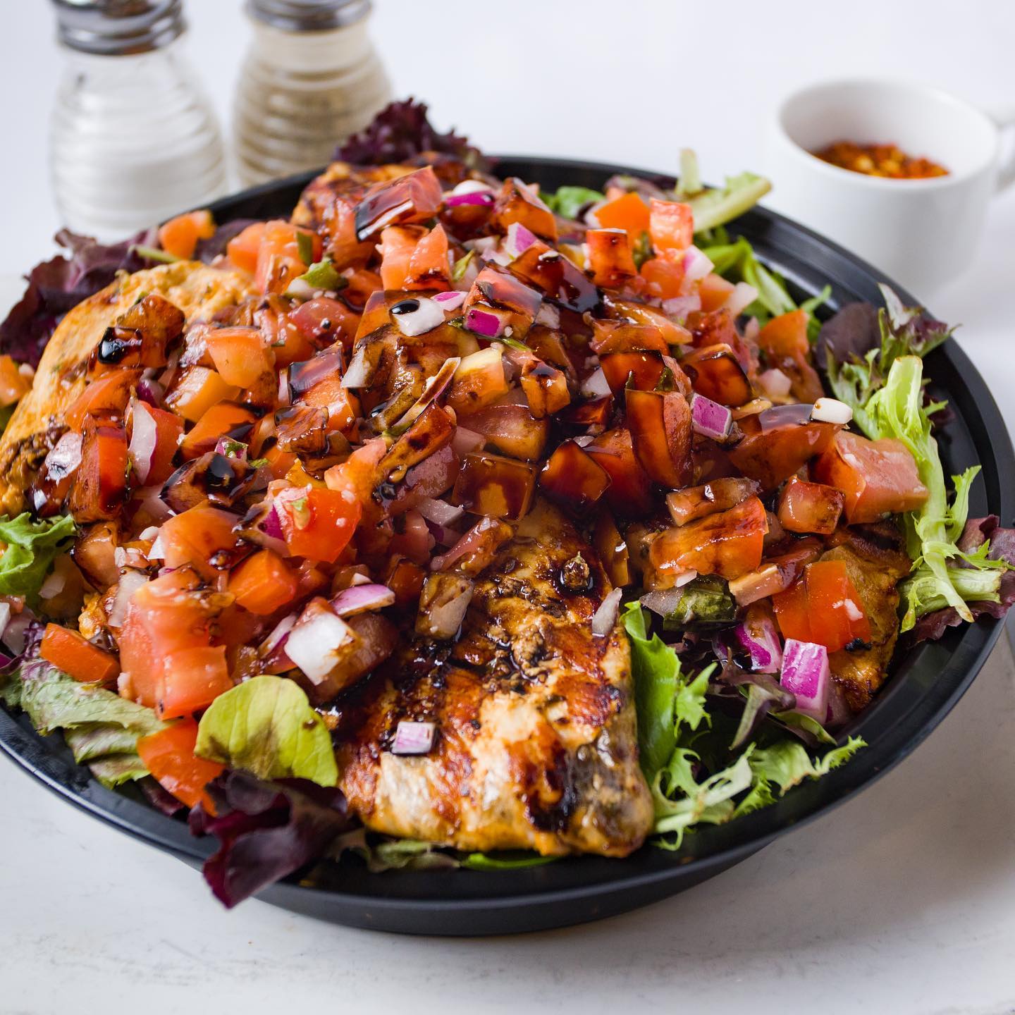 Grilled chicken topped with fresh tomato bruschetta