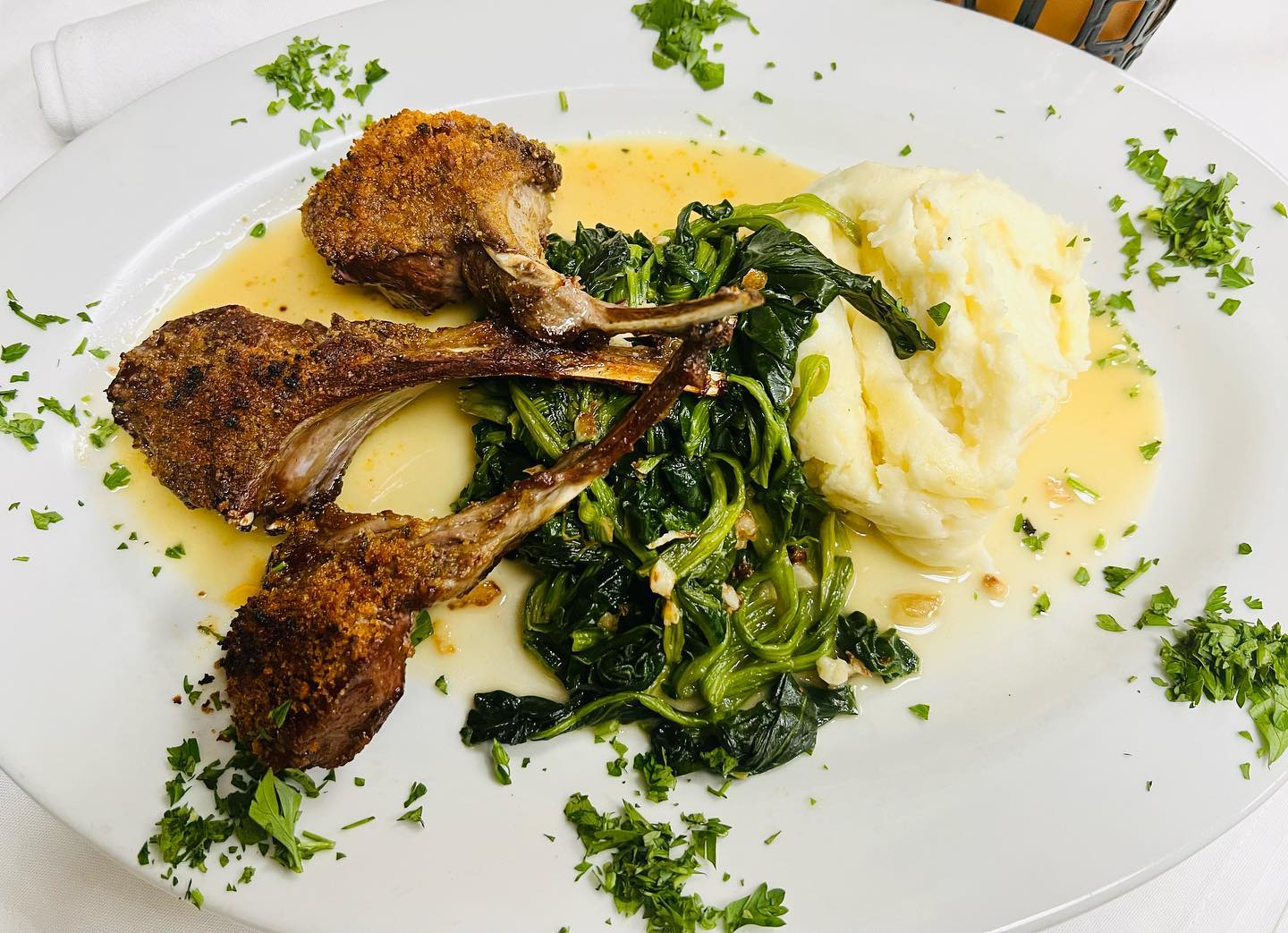 Breaded lamb chops with sautéed spinach and mashed potatoes