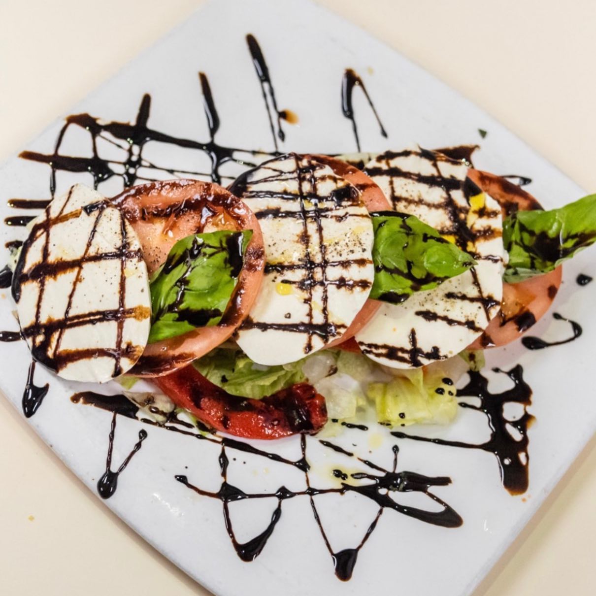 Caprese salad with mozzarella, tomato, and balsamic drizzle