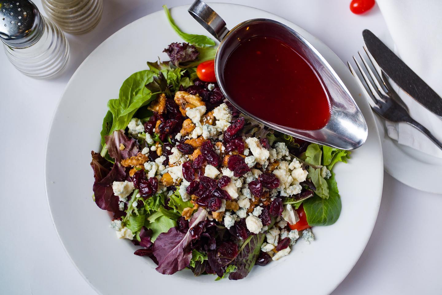 Mixed greens salad with cranberries, walnuts, and blue cheese