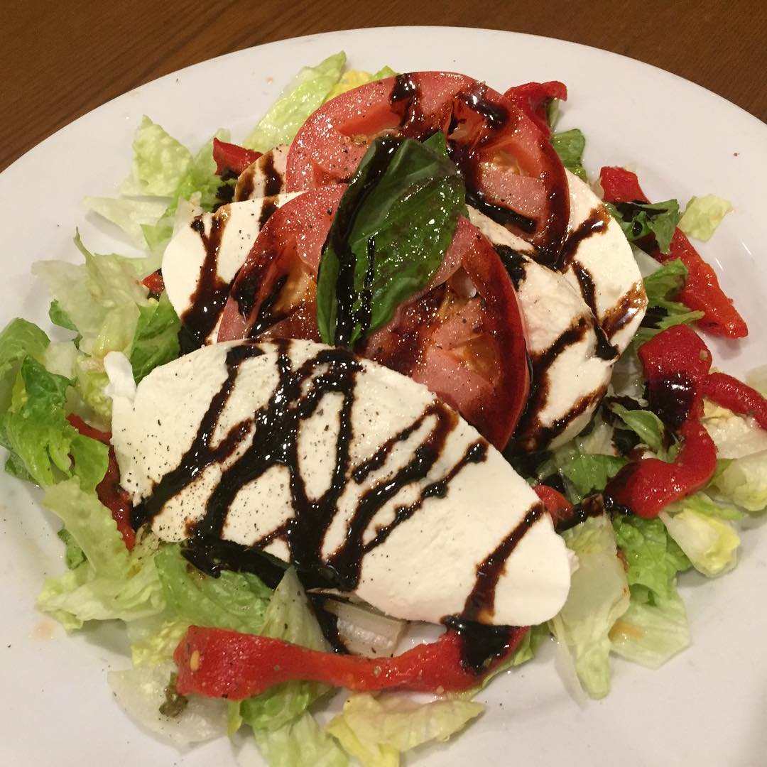 Caprese salad with balsamic drizzle and roasted peppers