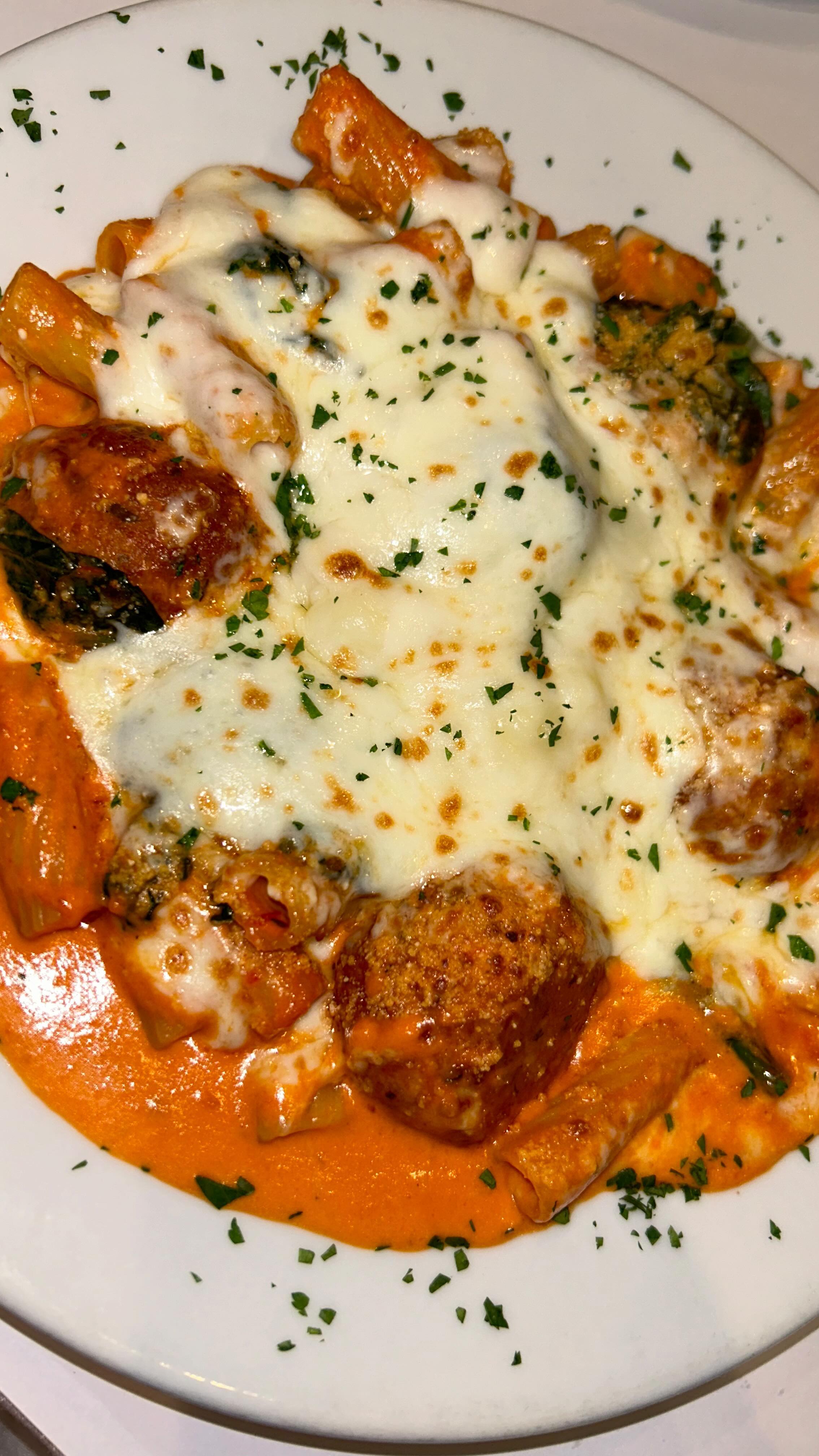 Baked rigatoni with meatballs in creamy tomato sauce