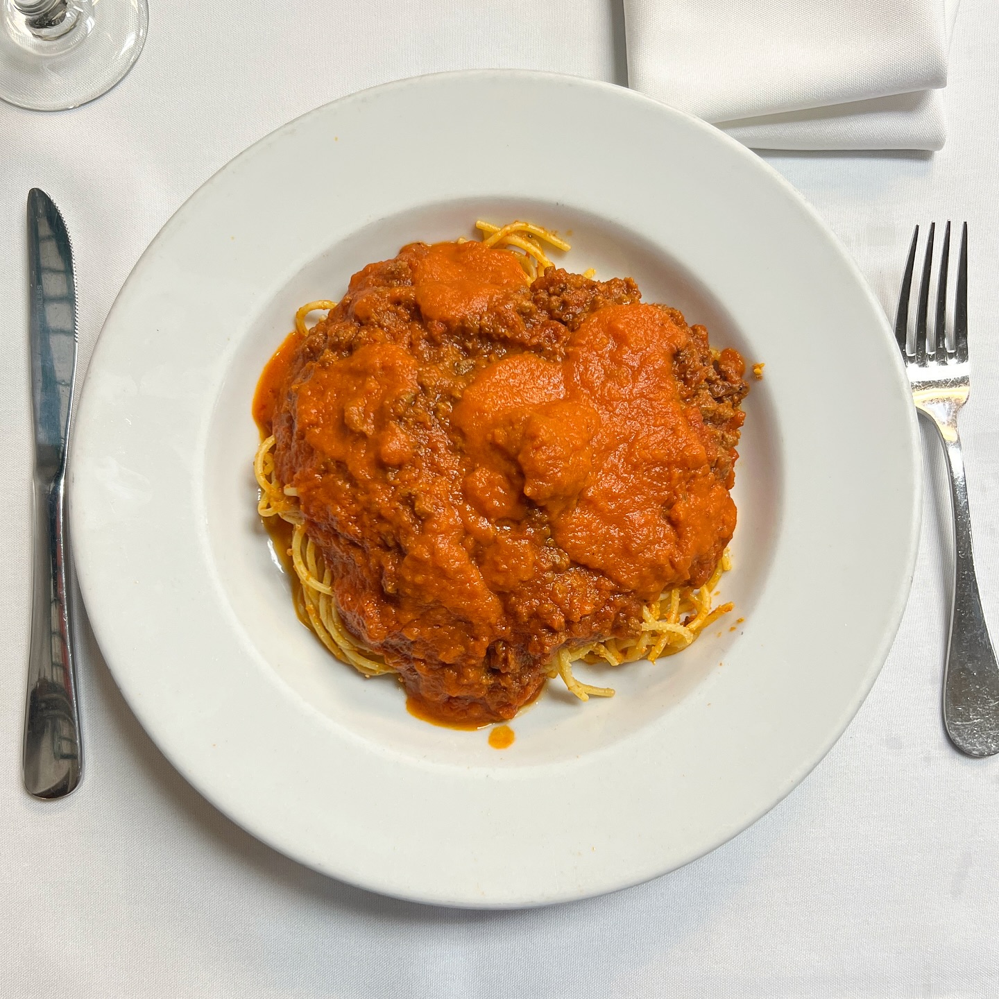 Spaghetti with meat sauce on a white plate