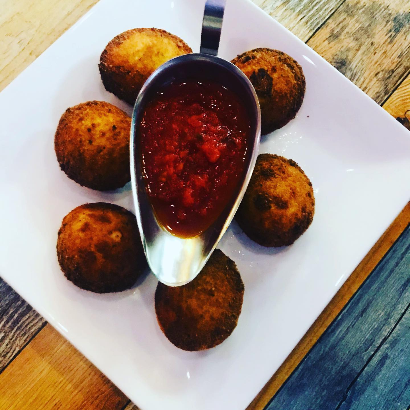 Fried arancini rice balls with raspberry dipping sauce