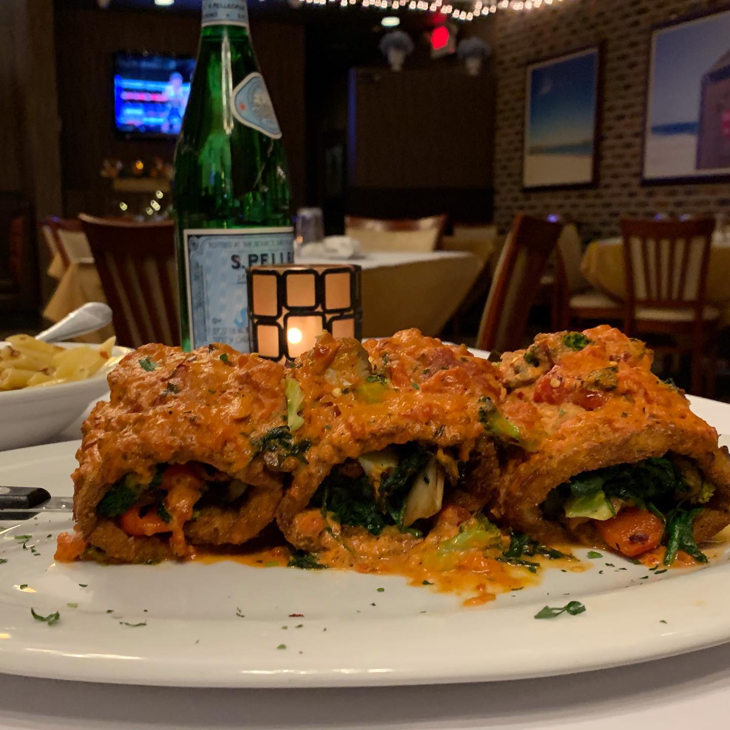 Stuffed rollatini with spinach and roasted peppers in tomato sauce