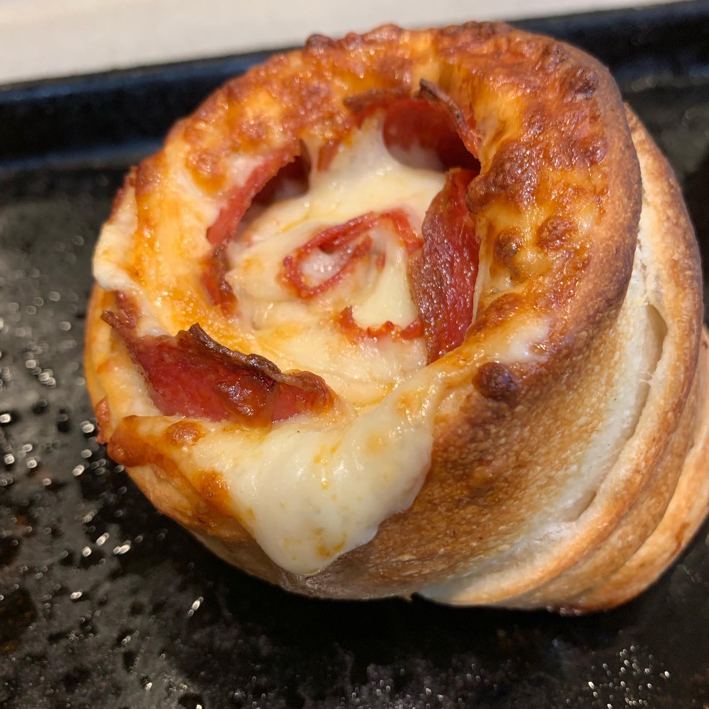 Pepperoni pizza roll cross-section with melted mozzarella