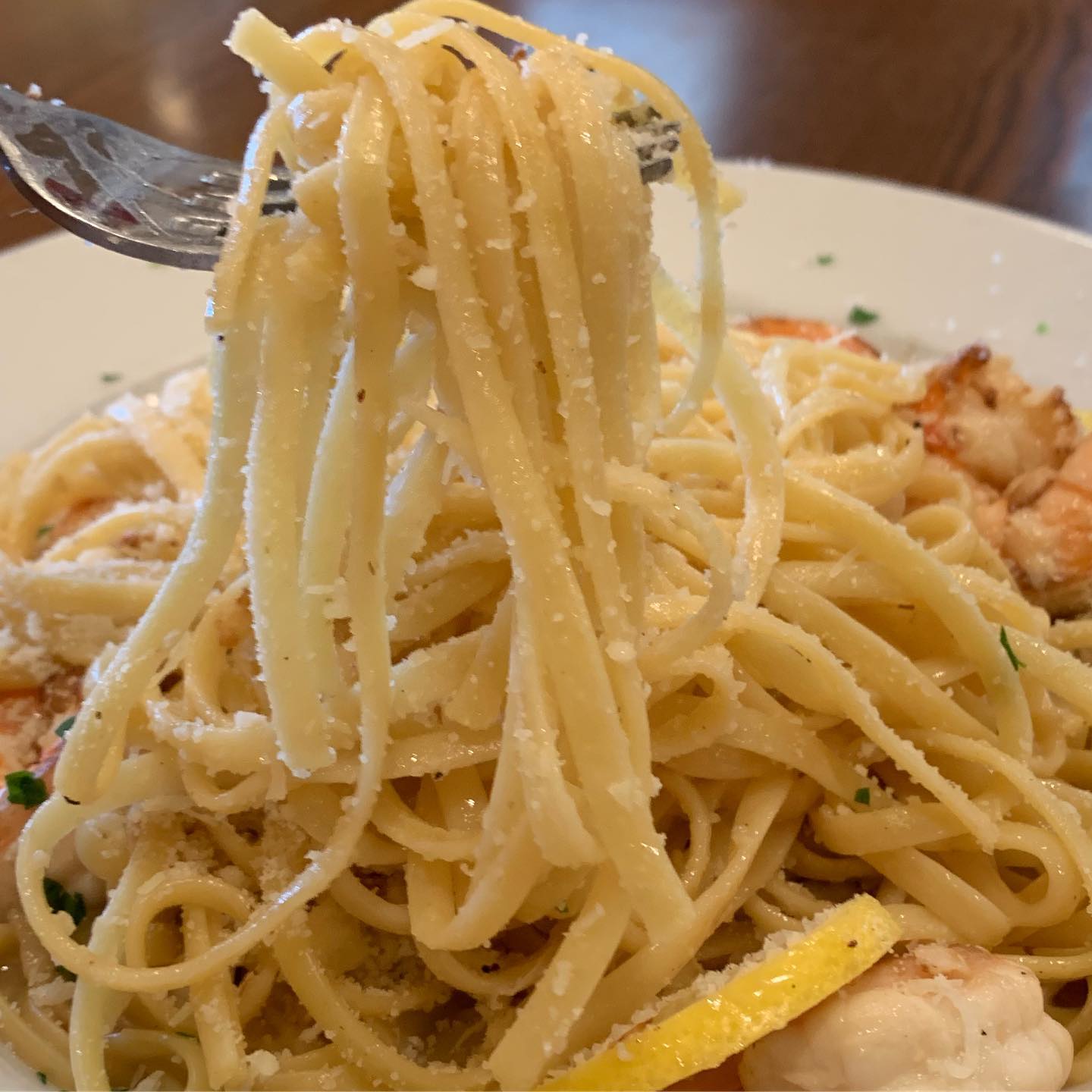 Linguine with shrimp in garlic butter, forkful close-up