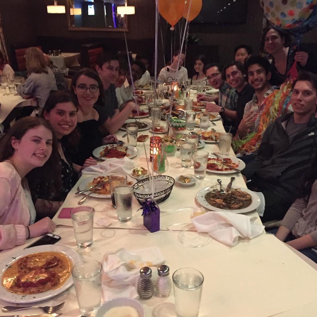 Group of customers celebrating at a long dining table
